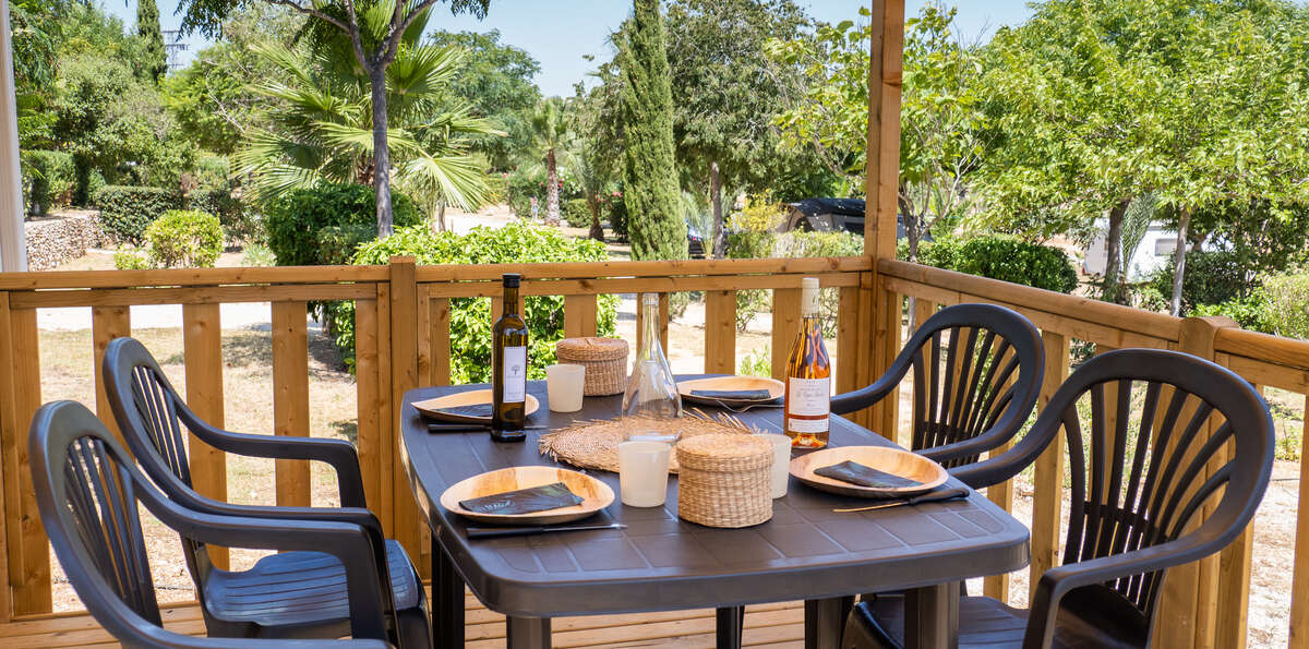 terrasse avec table pour quatre personnes au camping L'Orangeraie